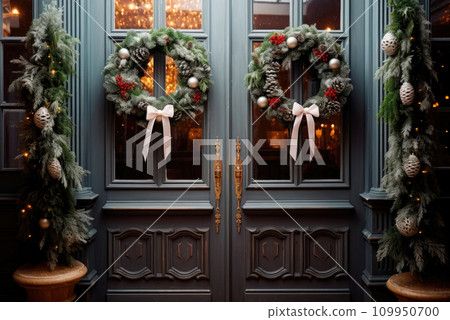 Christmas wreaths on the front pale blue doors of the house 109950700