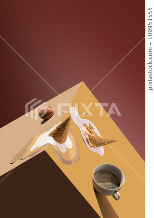 Coffee cup with spilling coffee and melting ice cream in waffle cone over brown background. Creative collage. Minimal art Coffee cup with spilling coffee and melting ice cream in waffle cone over brown background. Creative collage. Minimal art 109951555