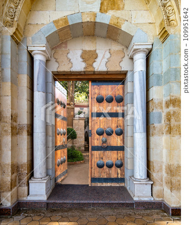 Detailed view of a intricate Mamluk style door, including dekoratif metalwork and timeworn handles Detailed view of a intricate Mamluk style door, including dekoratif metalwork and timeworn handles 109951642