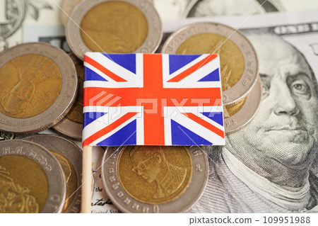 United Kingdom flag on coin and banknote money, finance trading investment business currency concept. 109951988