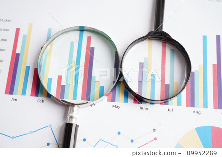 Magnifying glass on charts graphs paper. Financial development, Banking Account, Statistics, Investment Analytic research data economy. 109952289