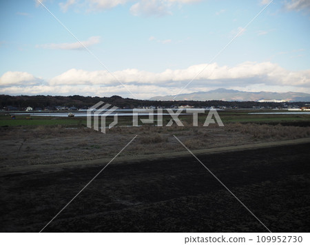 Winter landscape with rice fields and mountains Winter landscape with rice fields and mountains 109952730