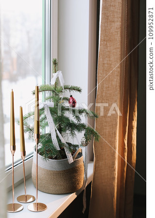 candles and decorations for the Christmas tree in eco style. Zero Waste Christmas concept. Vintage Christmas tree decorations. Holiday Template with Christmas decorations on fir tree candles and decorations for the Christmas tree in eco style. Zero Waste Christmas concept. Vintage Christmas tree decorations. Holiday Template with Christmas decorations on fir tree 109952871