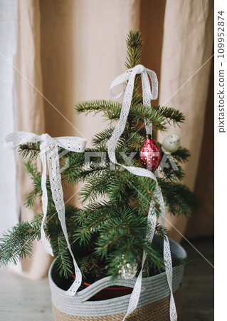 New Year lace decorations for the Christmas tree in eco style. Zero Waste Christmas concept. Vintage Christmas tree decorations. Holiday Template with Christmas decorations on fir tree  109952874