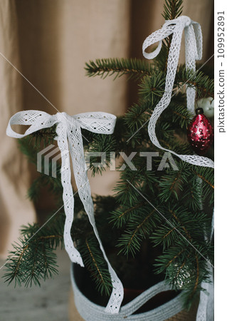 New Year lace decorations for the Christmas tree in eco style. Zero Waste Christmas concept. Vintage Christmas tree decorations. Holiday Template with Christmas decorations on fir tree  109952891