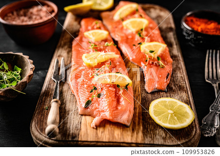 raw trout fillet red fish with lemon and spices ready for cooking raw trout fillet red fish with lemon and spices ready for cooking 109953826
