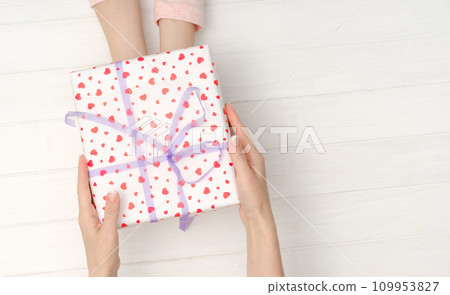 Girls hands holding lovely present box 109953827
