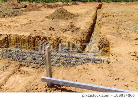 Underground reinforcement has been positioned in trench, foundation can now be poured 109954866