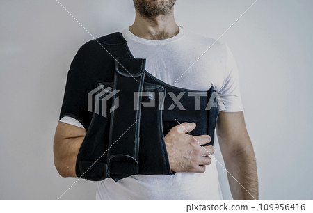 Shoulder orthosis orthoses orthopedic medical recovery sling for support hand background. 109956416