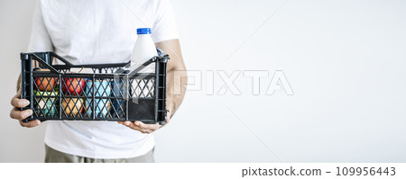Donate food box background. Donating grocery concept. Man with a box of food and products for charity 109956443