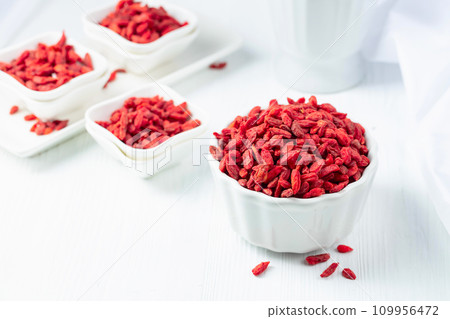 Dried goji berries on a white table. 109956472