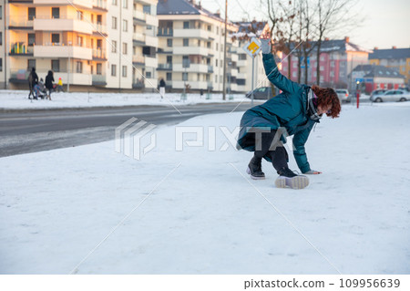 The girl slipped on the snow and fell. The girl slipped on the snow and fell. 109956639
