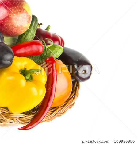 Fruits and vegetables in a wicker basket isolated on a white. Free space for text. Fruits and vegetables in a wicker basket isolated on a white. Free space for text. 109956990