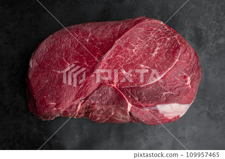 Raw beef steak on a dark slate background. Top view Raw beef steak on a dark slate background. Top view 109957465