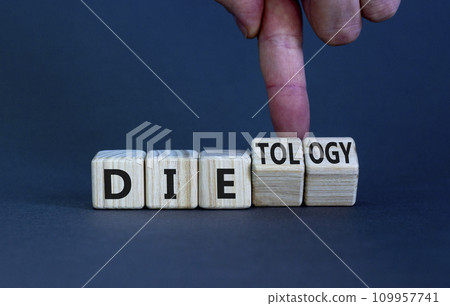 Dietology instead die symbol. Doctor turns wooden cubes and changes the word die to dietology. Beautiful grey table, grey background. Healthy lifestyle, dietology instead die concept. Copy space. 109957741