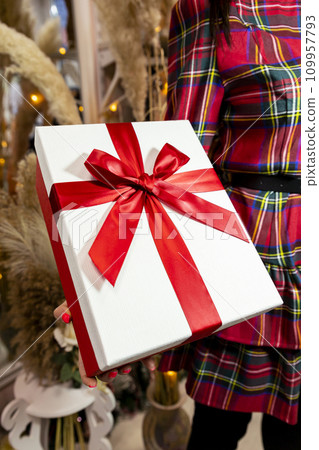 Present held in womans hand. Merry Christmas and Happy New Year Present held in womans hand. Merry Christmas and Happy New Year 109957793