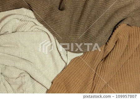 Knitted fabric wool sweater top view. Backgrounds and textures 109957807