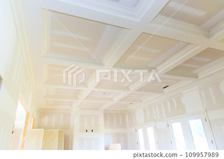 Plastering drywalling is being completed in preparation for painting new house 109957989