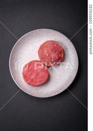 Round shape steaks of raw juicy tuna with salt and spices 109958282