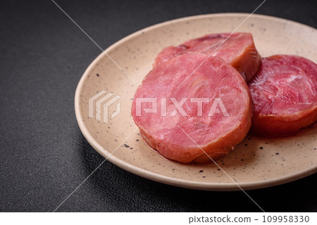 Round shape steaks of raw juicy tuna with salt and spices Round shape steaks of raw juicy tuna with salt and spices 109958330