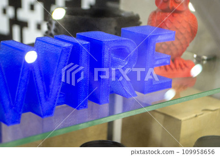 Objects letters printed on 3D printer close-up. Models letter 3D printed from molten plastic blue color. FDM technologies. Additive progressive modern new technology. 3D printing innovation technology Objects letters printed on 3D printer close-up. Models letter 3D printed from molten plastic blue color. FDM technologies. Additive progressive modern new technology. 3D printing innovation technology 109958656