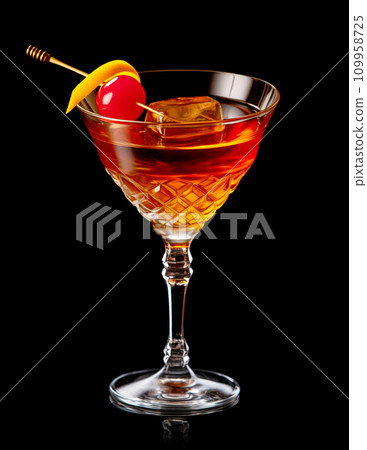 Refreshing Bourbon Manhattan cocktail with vermouth and maraschino cherry garnish isolated on black background/ 109958725