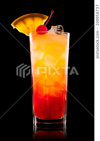 Tequila Sunrise cocktail blend of tequila, orange juice, and grenadine on black 109958737