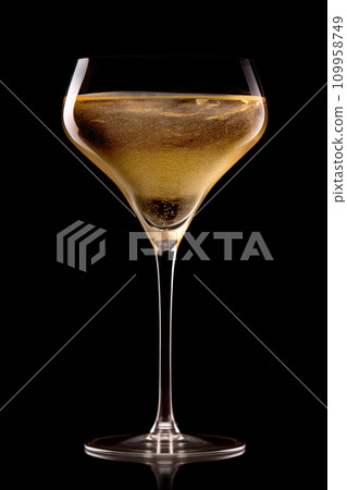 A crystal-clear flute glass of champagne isolated on black background 109958749