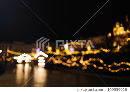 Blurred stylish christmas golden illumination and Christmas tree. Krakow, Poland, Main Square and Cloth Hall in the winter season, during Christmas fairs decorated with Christmas tree.  109959026