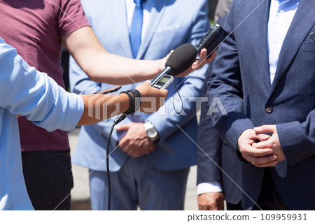 Reporters making media interview with unrecognizable businessman or politician Reporters making media interview with unrecognizable businessman or politician 109959931