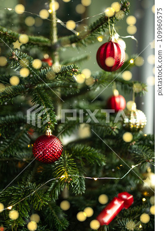 Close up of decorated Christmas tree with glitter effects on blurred background. New Year concept. Close up of decorated Christmas tree with glitter effects on blurred background. New Year concept. 109960575