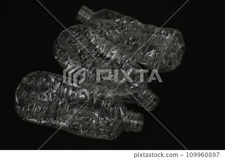 Crushed empty plastic bottle on black background 109960897