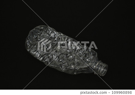 Crushed empty plastic bottle on black background 109960898