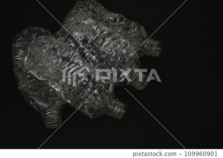Crushed empty plastic bottle on black background Crushed empty plastic bottle on black background 109960901