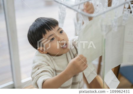 Recycling milk cartons: A boy dries washed paper cartons 109962431