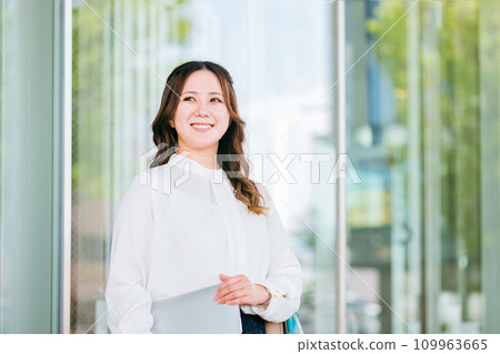 Office casual office lady/business woman walking around the building with a laptop 109963665