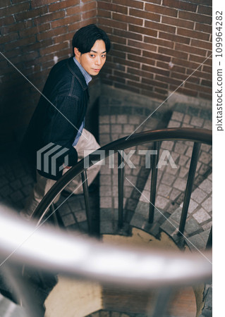 A man climbing up the stairs A man climbing up the stairs 109964282