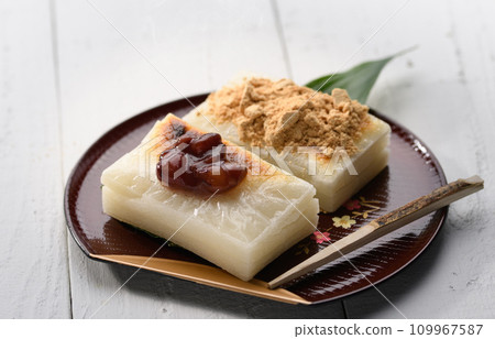 Freshly baked cut mochi topped with red bean paste and soybean flour Freshly baked cut mochi topped with red bean paste and soybean flour 109967587