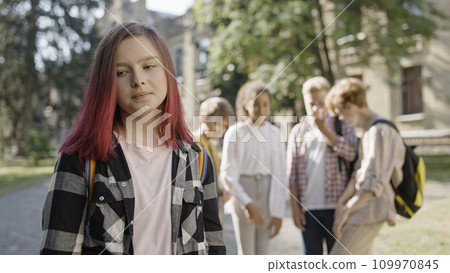 School children laughing looking at new girl, bullying, disrespect for classmate School children laughing looking at new girl, bullying, disrespect for classmate 109970845