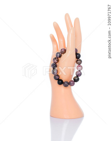 A graceful mannequin's hand is displayed, adorned with an elegant bracelet, emphasizing its beauty and uniqueness. A graceful mannequin's hand is displayed, adorned with an elegant bracelet, emphasizing its beauty and uniqueness. 109971767