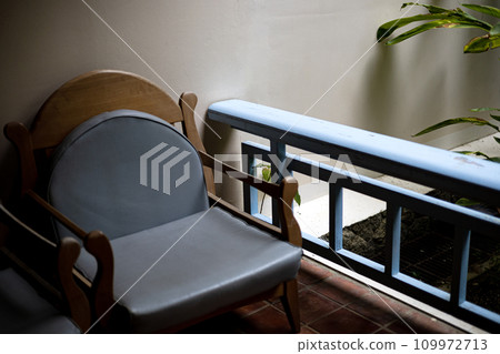 Beautiful terrace or balcony with chair.  Vintage image terrace home balcony view. Wooden Chair On Balcony. 109972713