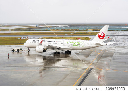Rainy airport, passenger plane and towing tractor, Naha City, Okinawa Prefecture Rainy airport, passenger plane and towing tractor, Naha City, Okinawa Prefecture 109973653