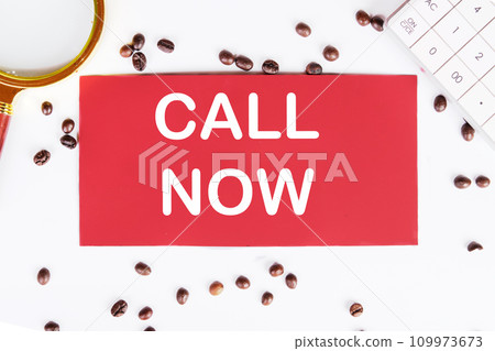 Call now writing on a red card on a white background with coffee beans and a magnifying glass 109973673