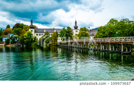 Sunshine wooden bridge over the lake with turquoise water in Hallstatt, Austria Sunshine wooden bridge over the lake with turquoise water in Hallstatt, Austria 109973687