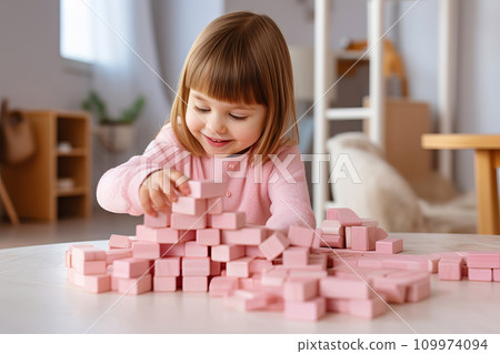 Cute little girl playing with pink wooden blocks. Sustainable eco friendly toys Cute little girl playing with pink wooden blocks. Sustainable eco friendly toys 109974094