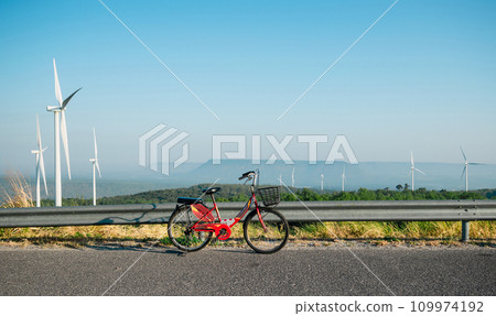 Clean energy concepts bicycles and wind turbines produce electricity. 109974192