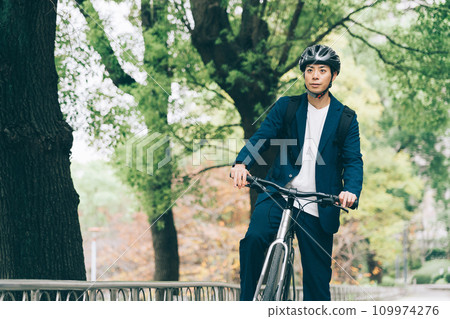 A businessman riding a bicycle 109974276