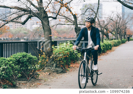 A businessman riding a bicycle A businessman riding a bicycle 109974286