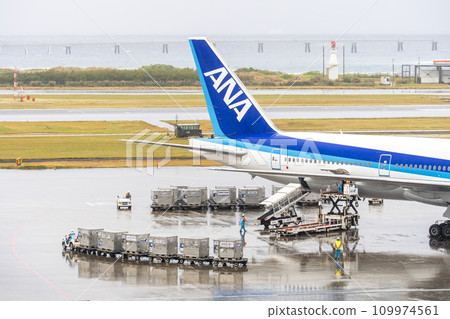 Rainy airport loading tug cars and luggage Naha City, Okinawa Prefecture Rainy airport loading tug cars and luggage Naha City, Okinawa Prefecture 109974561