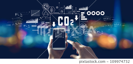 Reduce CO2 theme with person using a smartphone at night 109974732